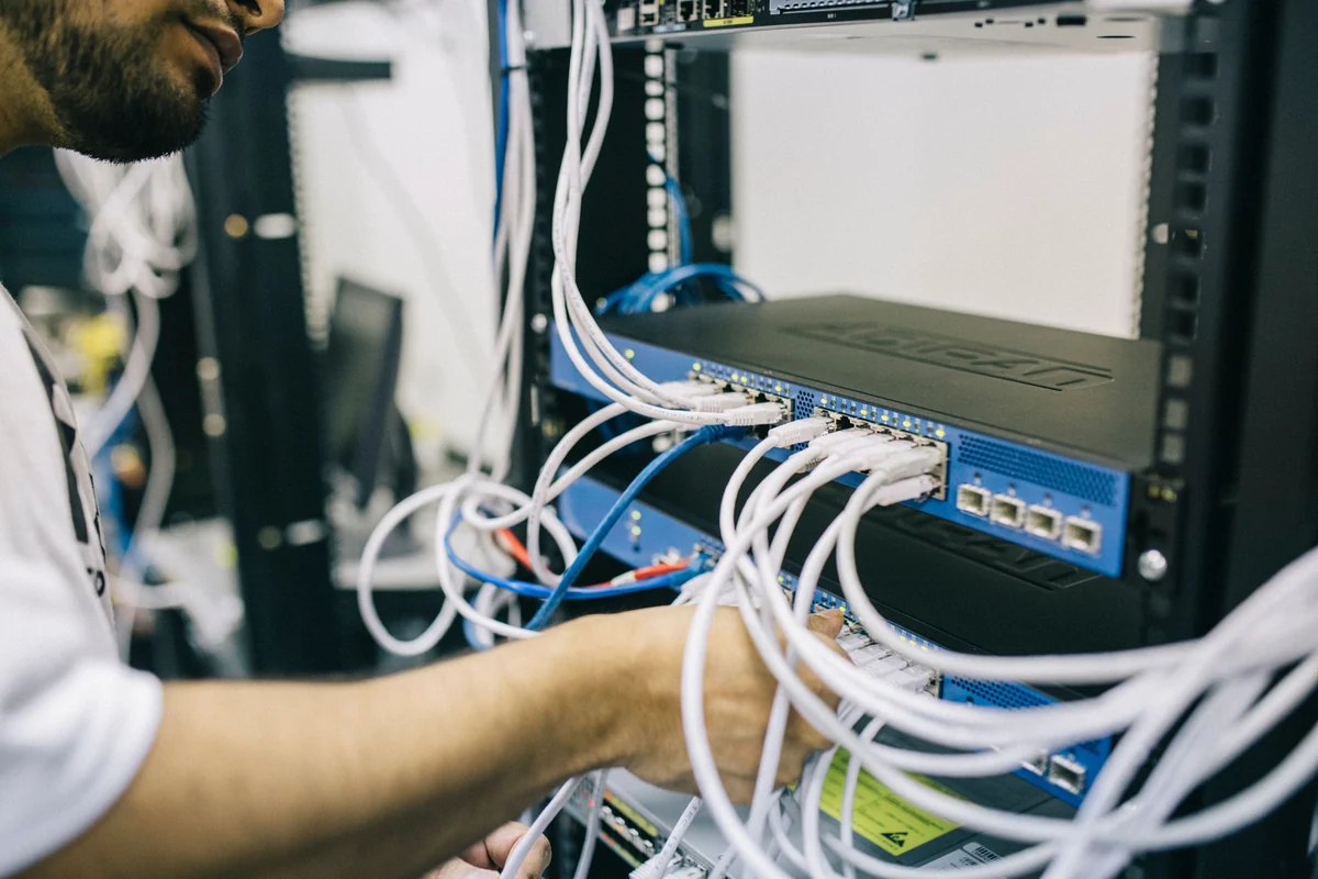 IT technician working on a network rack